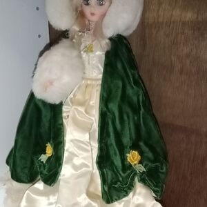 Elegant Doll with Green Cape and Cream Dress